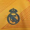 maillotrealmadridexterieurorangelogo.jpg Maglia Real Madrid Away 2024-2025 dettaglio tessuto